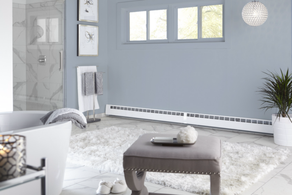 Revital/Line baseboard cover installed in bathroom with blue accent wall